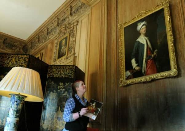 Sue Jordan looking at the portrait of John Montagu the 4th Earl of Sandwich