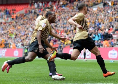 Nahki Wells celebrates his goal chased by Kyel Reid and James Meredith.
