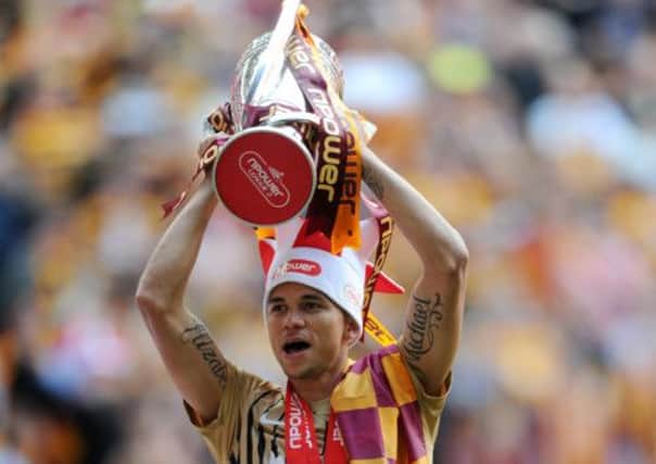Nahki Wells celebrates with the play off trophy.