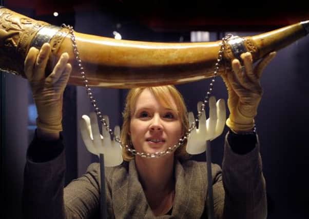 Vicky Harrison, Collections Manager, with the Horn of Ulphdating from Saxon times