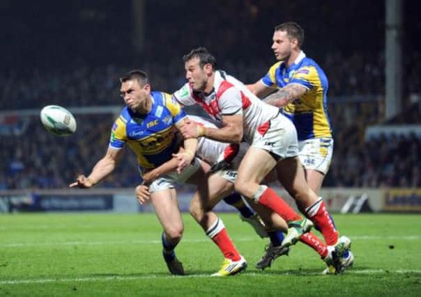 Kevin Sinfield releases the ball under pressure
