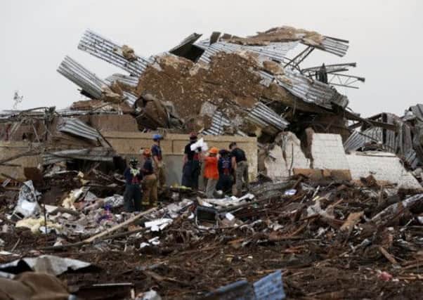 A tornado roared through the Oklahoma City suburbs Monday, flattening entire neighborhoods