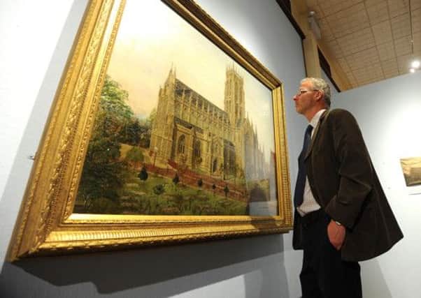 Neil McGregor, museums officer, views the painting of St George's Church at Doncaster Museum