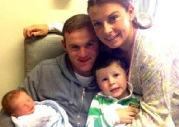 Twitter picture of Wayne Rooney holding his newborn son Klay Anthony Rooney, with wife Coleen and his eldest son Kai