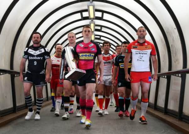 Captains for the 14 Super League clubs head towards the Deansgate Tram platform in Manchester on their way to the Etihad Stadium for the Magic Weekend.