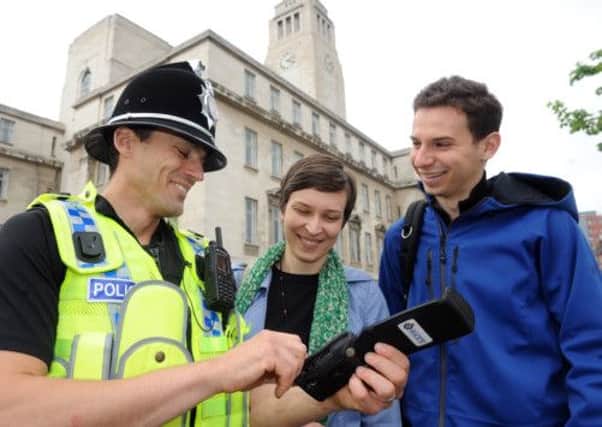 PC Matt Guy chats to studenst Kata Pauly and Justin Koufopoulos at Leeds University.