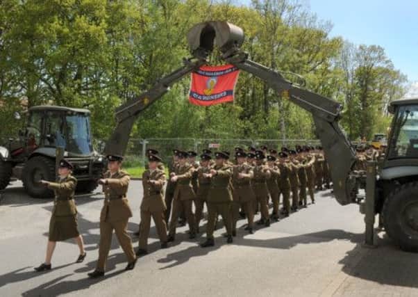 Soldiers from 10 Field Squadron (Air Support)  39 Engineering Regiment of the Royal Engineers march for the final time under an arch made from JCB diggers  at RAF Leeming