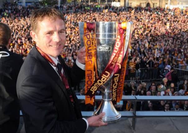 Bradford City manager Phil Parkinson holds aloft the cup to fans in City Park