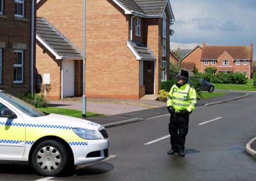 Police close a road in Saxilby, Lincolnshire leading to a house which was raided in connection with the attack in Woolwich