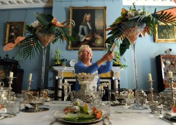 Maragaret Baxter from New Earswick Flower Club  working on the centrepieces of the dining table at Fairfax House in York