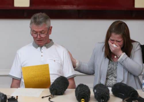 Family members of murdered soldier Lee Rigby, his stepfather Ian Rigby and wife Rebecca Rigby, as his stepfather reads a statement at a press conference at the Regimental HQ of his unit.
