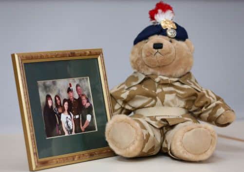 A teddy bear bought by murdered soldier Lee Rigby for his son, Jack, sits alongside a family photograph