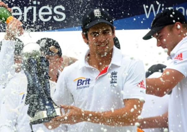 England's Alastair Cook gets covered in Champagne while celebrating winning the test series against New Zealand
