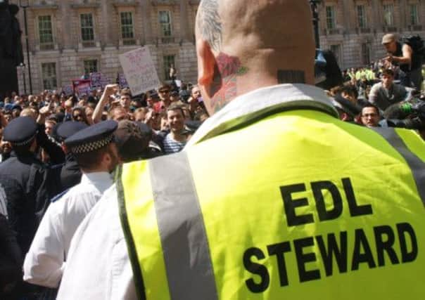 An EDL steward faces a crowd of anti-fascists demonstrators outside Downing Street earlier this week.