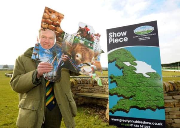 Bill Cowling, show director of the Great Yorkshire Show with the 'missing' piece of a giant jigsaw showing pictures from the show