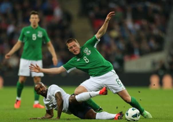 Republic of Ireland's James McCarthy (right) and England's Jermain Defoe (left) battle for the ball