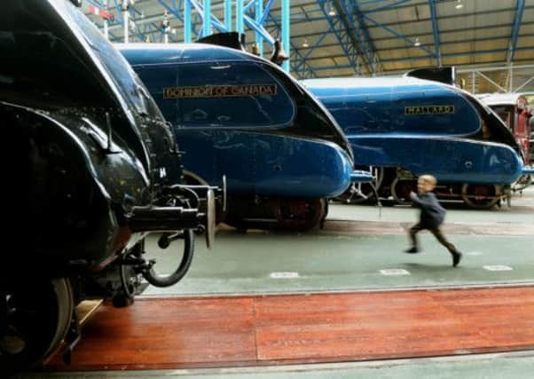 Thrilled at seeing the sister locomotives Dwight D Eisenhower (left) Dominion of Canada (centre) back with Mallard at the National Railway museum in York is Charle Schofield 5 from Newcastle as he speeds past the locvomotives. PIC: Gary Longbottom