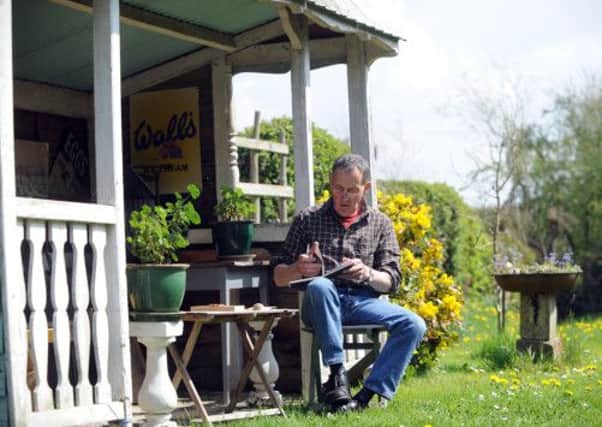 Chris Philipson in his garden working on his designs