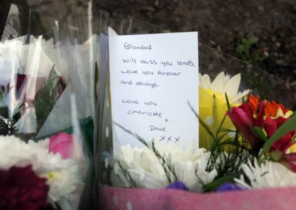 A floral tribute in Pudsey Park after an elderley man was killed by a police van which rolled forward as officers where dealing with reports of a disturbance