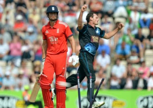 England's Alastair Cook reacts after is bowled out by New Zealand's Kyle Mills