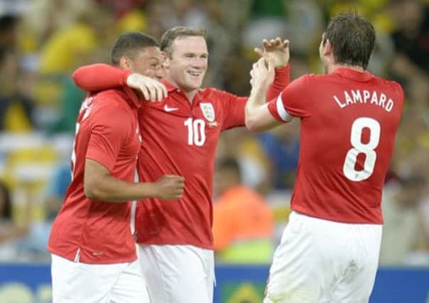 England's Wayne Rooney (centre) celebrates scoring their second goal of the game with team-mates Alex Oxlade-Chamberlain and Frank Lampard (right) during the International Friendly at the Maracana Stadium in Rio De Janeiro, Brazil. (Picture: Owen Humphreys/PA Wire).