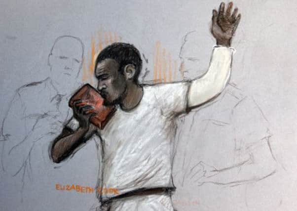 Court artist sketch by Elizabeth Cook Michael Adebolajo kissing the Koran as he appears at Westminster Magistrates Court