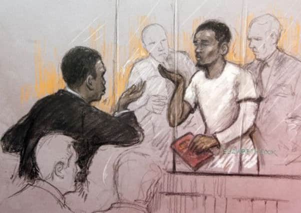 Court artist sketch by Elizabeth Cook of a member of the public blowing kisses at Michael Adebolajo in the dock at Westminster Magistrates Court