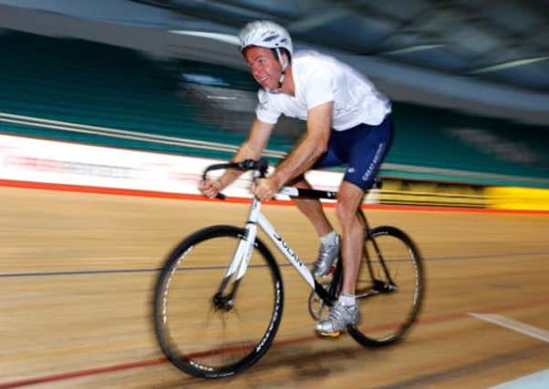 Laureus Academy Ambassador Michael Vaughan races in a time trial during the PruProtect Chance to Ride Launch
