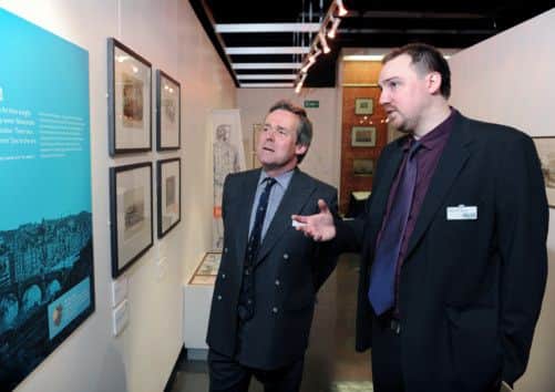 Curator of Industry Mark Carlyle shows Lord St Oswald around the exhibition.