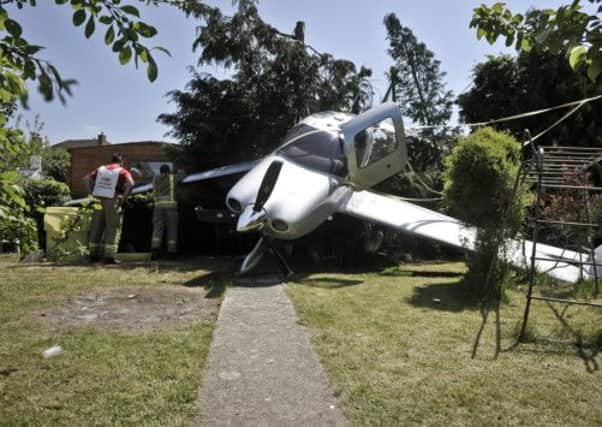 The Cirrus single-engine aircraft after it made a dramatic crash-landing in a back garden in Cheltenham, Gloucestershire.