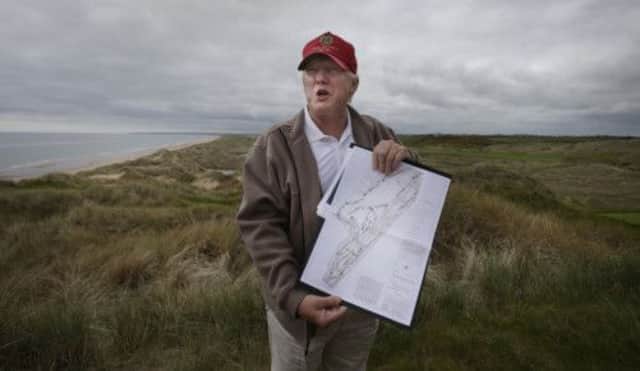 Donald Trump holds the plans for The MacLeod Course, his second Scottish golf course