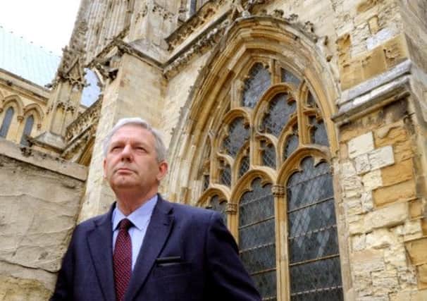 Dr Richard Shepard the York Minster Chamberlain in front of some of the stonework that is crumbling on York Minster