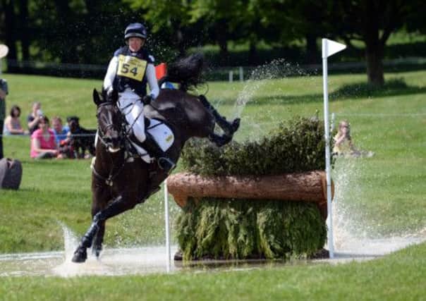 Nicola Wilson on Annie Clover jumps one of the water fences during the Cross Country Section on day three of the Equi-Trek Bramham International Horse Trials, at Bramham Park, Wetherby.