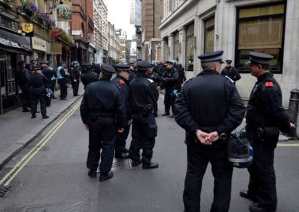 Police officers on duty in Soho, central London, where protesters with banners were believed to be occupying a former police station in Beak Street amid demonstrations ahead of the G8 conference in Northern Ireland next week. PIC: PA