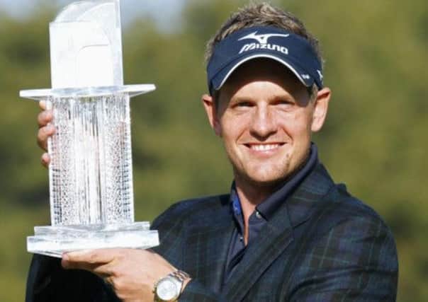 Luke Donald of England poses with his trophy
