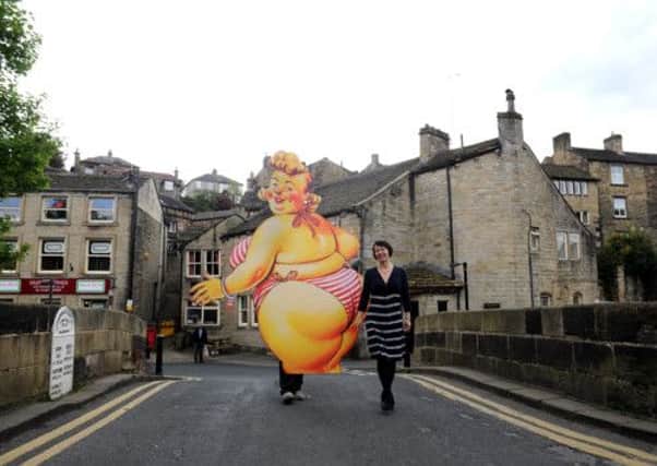 'Bamforth Beryl' is carried across Toll Booth Bridge, Holmfirth along side festival director Fiona Goh to mark the launch of the Holmfirth Arts Festival and below, Melvyn Bragg.