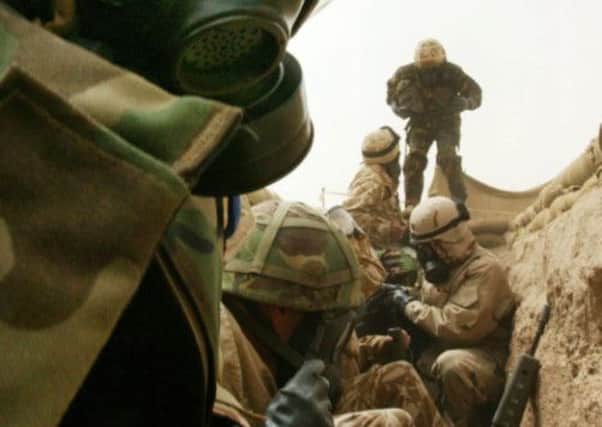 American and British troops take shelter in 'scud trenches' during an unconfirmed Iraqi missile attack in the Kuwaiti desert in 2003