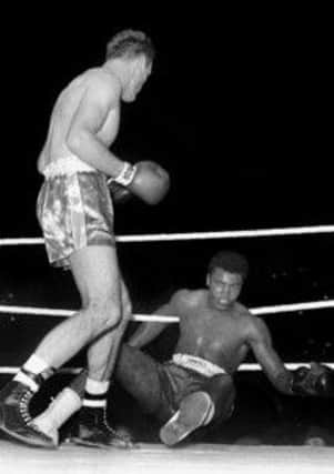 Cassius Clay, now Muhammad Ali, being knocked down by Henry Cooper.  (Picture: PA Wire)
