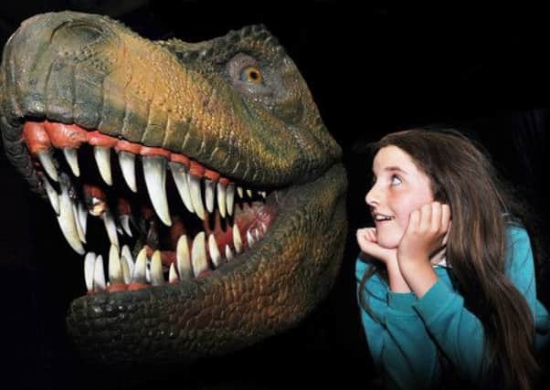 Elizabeth Bateman from Nook Lane School, Sheffield, comes face to face with a T-Rex.