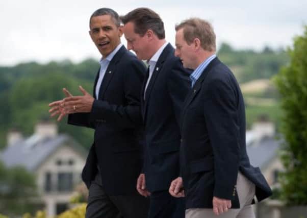 Prime Minister David Cameron walks to lunch with US President Barack Obama and Irish Prime Minister Enda Kenny