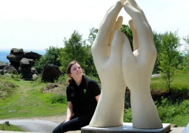 Hayley Schofield  looks at  'Dreamcatcher' a sculpture by  at Brimham Rocks  near Ripon.