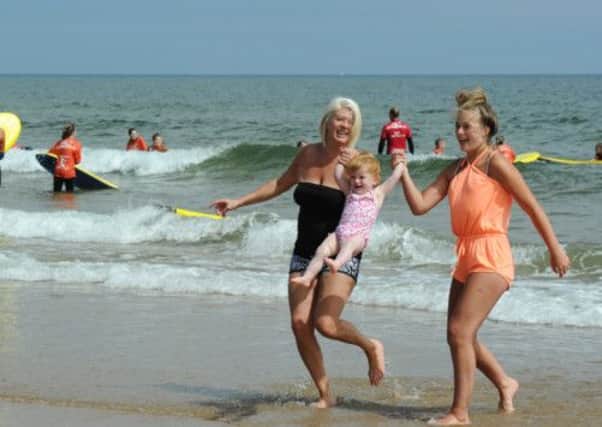 Sharon Jamesieson (left), Nadia 20 months old, and Nadia Jamesieson, aged 16, from North Tyneside enjoy the sun on Tynemouth Beach