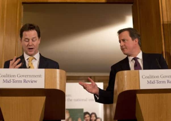 Prime Minister and leader of the Conservative Party, David Cameron, right, and Deputy Prime Minister and Liberal Democrats leader Nick Clegg (left)  at a press conference at  10 Downing Street, London at the launch the mid-term review. PRESS ASSOCIATION Photo.
