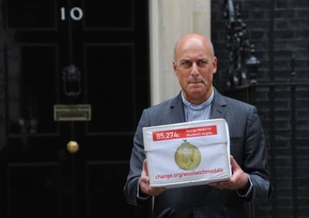 The Rev Jesse van der Falk, Rector of Woolwich delivers the petition to 10 Downing Street