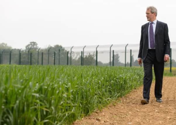Environment secretary Owen Paterson views a genetically modified crop trial during a visit to Rothamsted Research, in Harpenden, Hertfordshire.