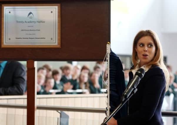 Princess Beatrice reacts after accidently pulling off the curtain rail after officially opening Trinity Academy school in Halifax.