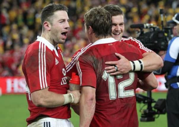 British and Irish Lions' Alex Cuthbert (left) celebrates after the final whistle with Jonathan Davies (centre) and Dan Lydiate (right)