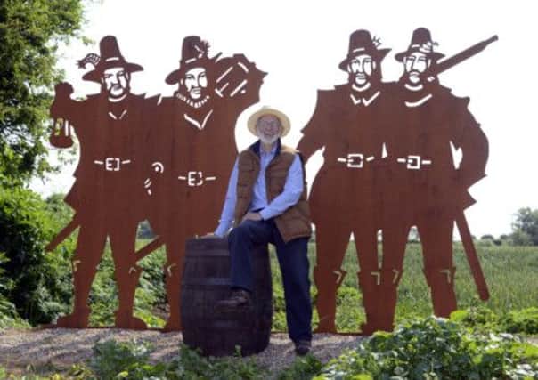 Artist Larry Malkin with his sculpture of Guy Fawkes, Robert Catesby, and local plotters John and Christopher Wright at Welwick, near Hull.