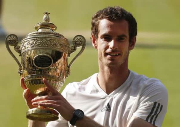 Great Britain's Andy Murray celebrates with the trophy after defeating Serbia's Novak Djokovic