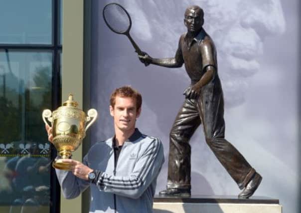 Andy Murray with the Mens Single's Trophy during the photocall by the Fred Perry statue